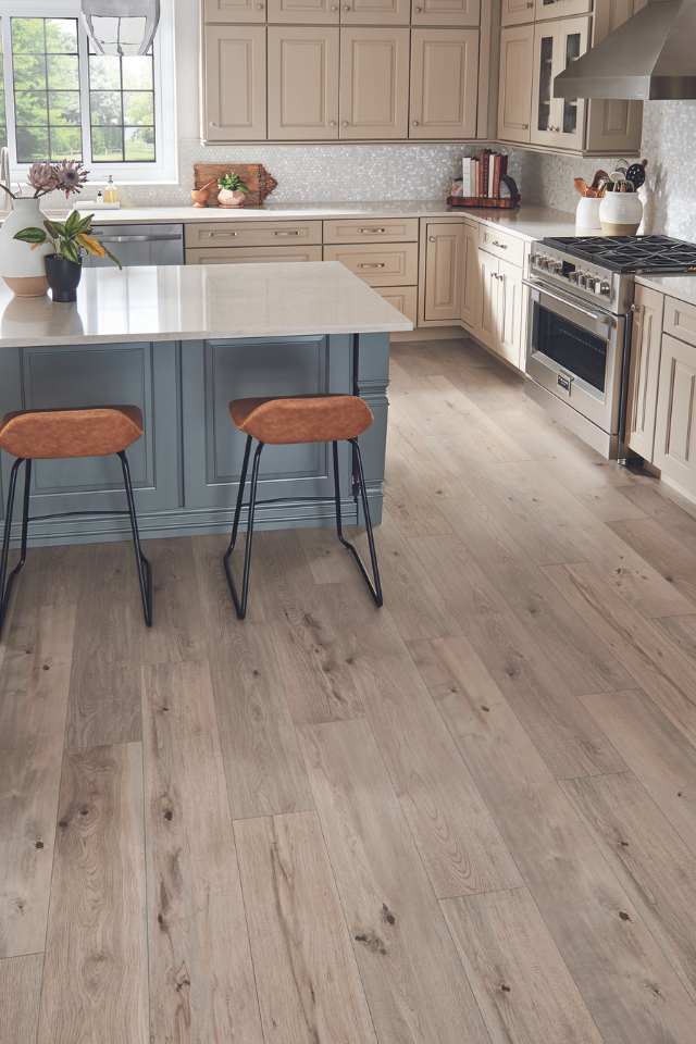 wood look laminate flooring in kitchen with blue island and leather bar stools